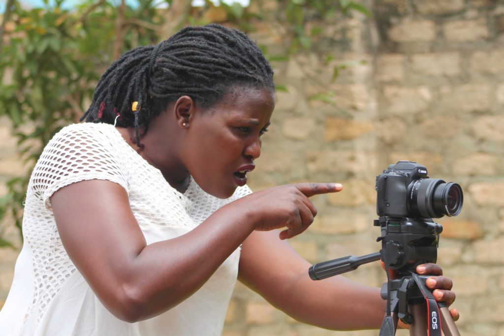 Film training, a woman learns to use a dslr camera, Canon m50, in Kabale district